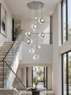 Gold Crystal Spiral Chandelier for Staircase Foyer in chrome finish installed in a bright modern stairwell
