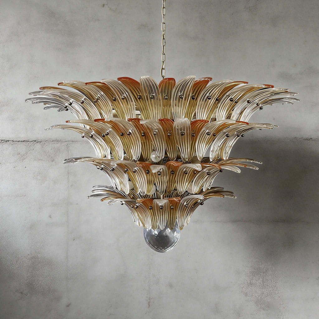 Amber glass Palmette chandelier shown in a large tiered studio view on a gray wall.