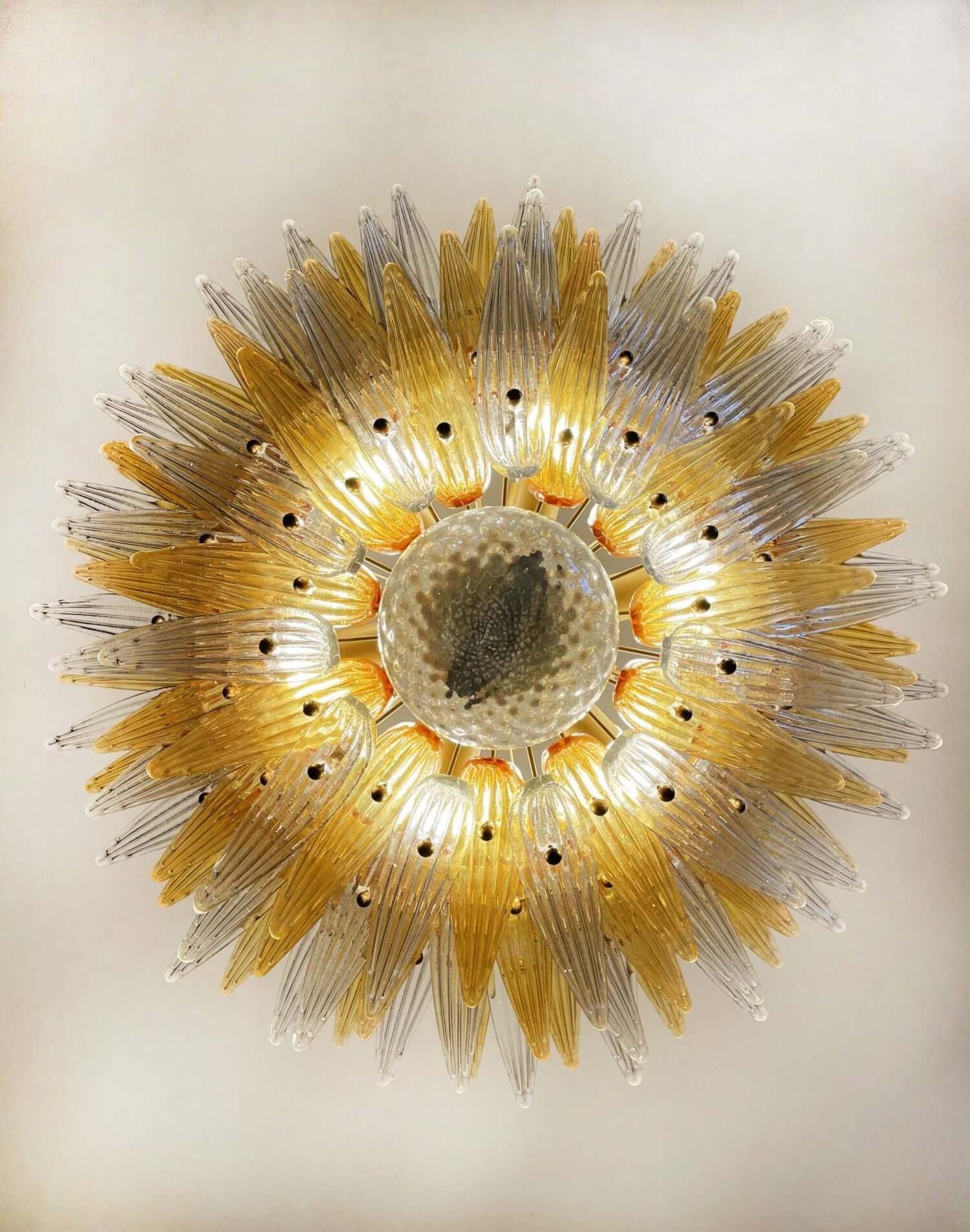 Underside view of the amber glass Palmette chandelier with layered leaf shades.