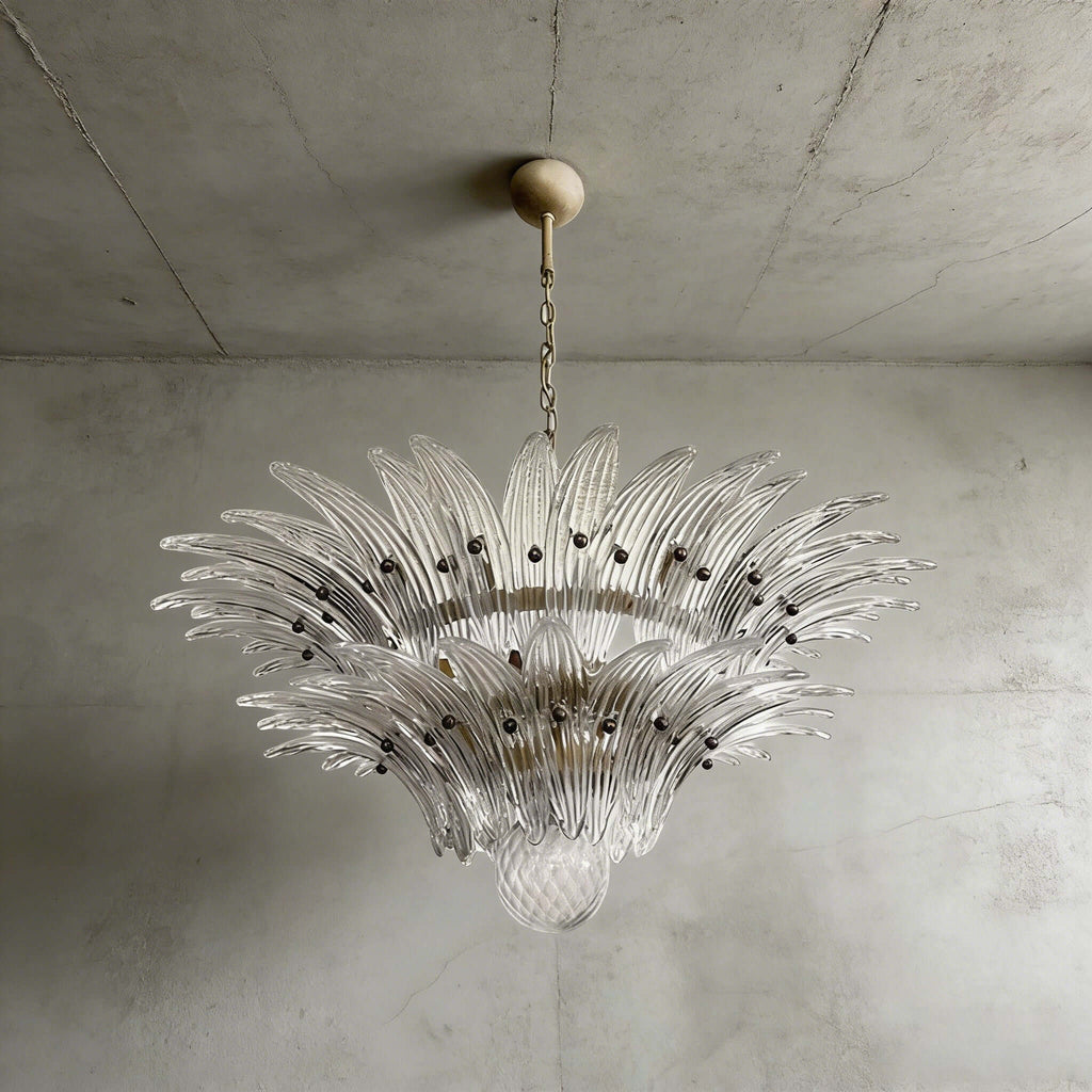Clear glass Palmette chandelier shown in a compact studio view on a gray wall.