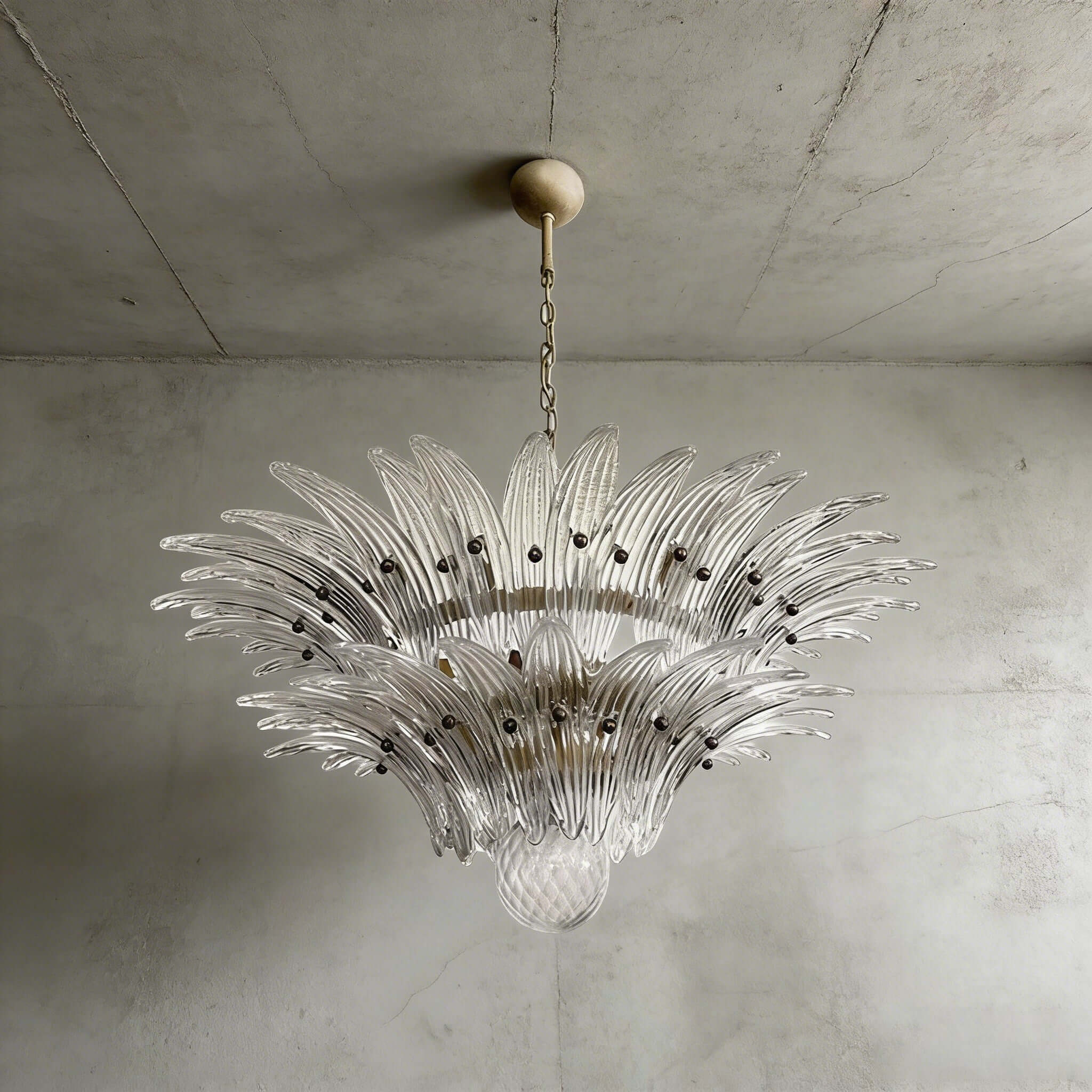 Clear glass Palmette chandelier shown in a compact studio view on a gray wall.