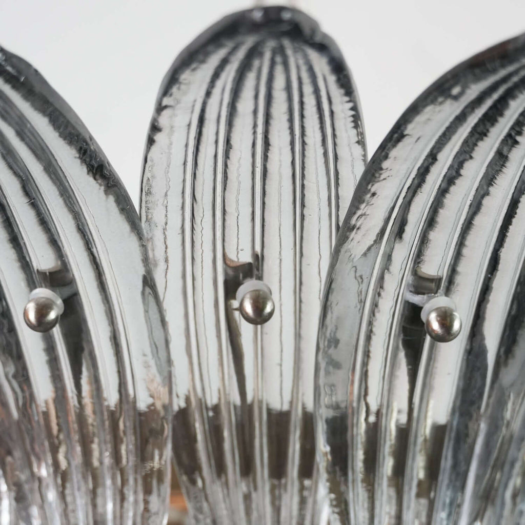 Close-up of clear ribbed glass leaves on the Murano Palmette chandelier.