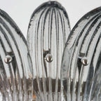 Close-up of clear ribbed glass leaves on the Murano Palmette chandelier.