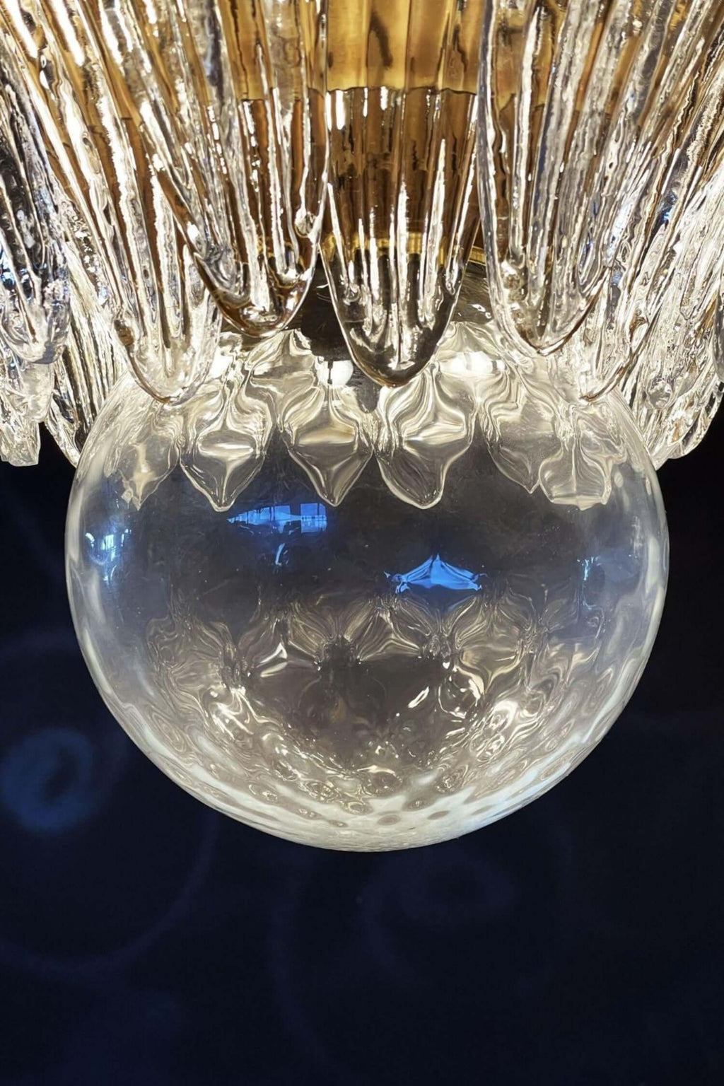 Close-up of the clear glass globe beneath the Palmette chandelier.