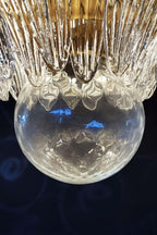Close-up of the clear glass globe beneath the Palmette chandelier.