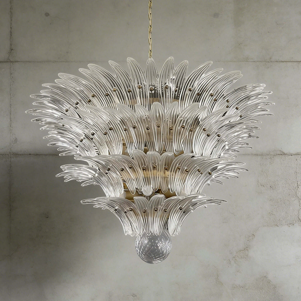 Clear glass Palmette chandelier shown in a large tiered studio view on a gray wall.