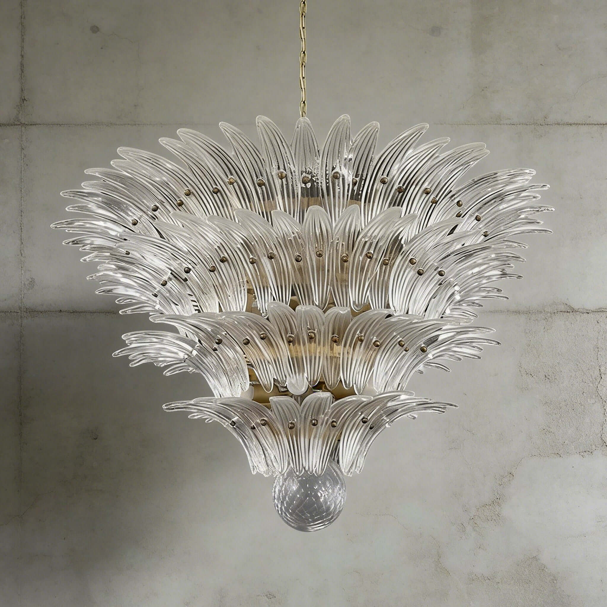 Clear glass Palmette chandelier shown in a large tiered studio view on a gray wall.