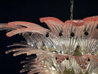 Close-up of pink glass leaf edges and clear glass layers on the chandelier.