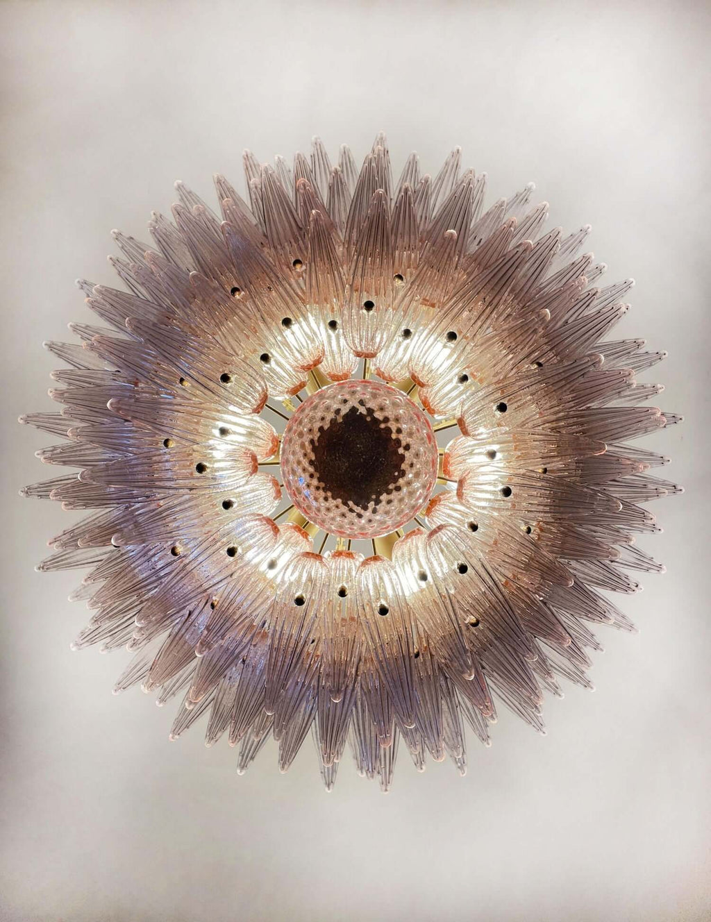 Underside view of the pink glass Palmette chandelier with tiered leaf shades.