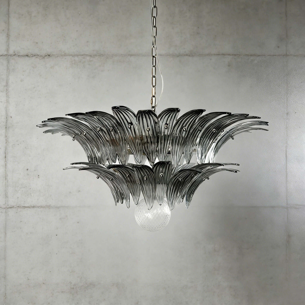 Smoky gray glass Palmette chandelier shown in a compact studio view on a gray wall.
