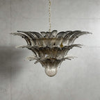 Smoky gray glass Palmette chandelier shown in a wider studio view on a gray wall.