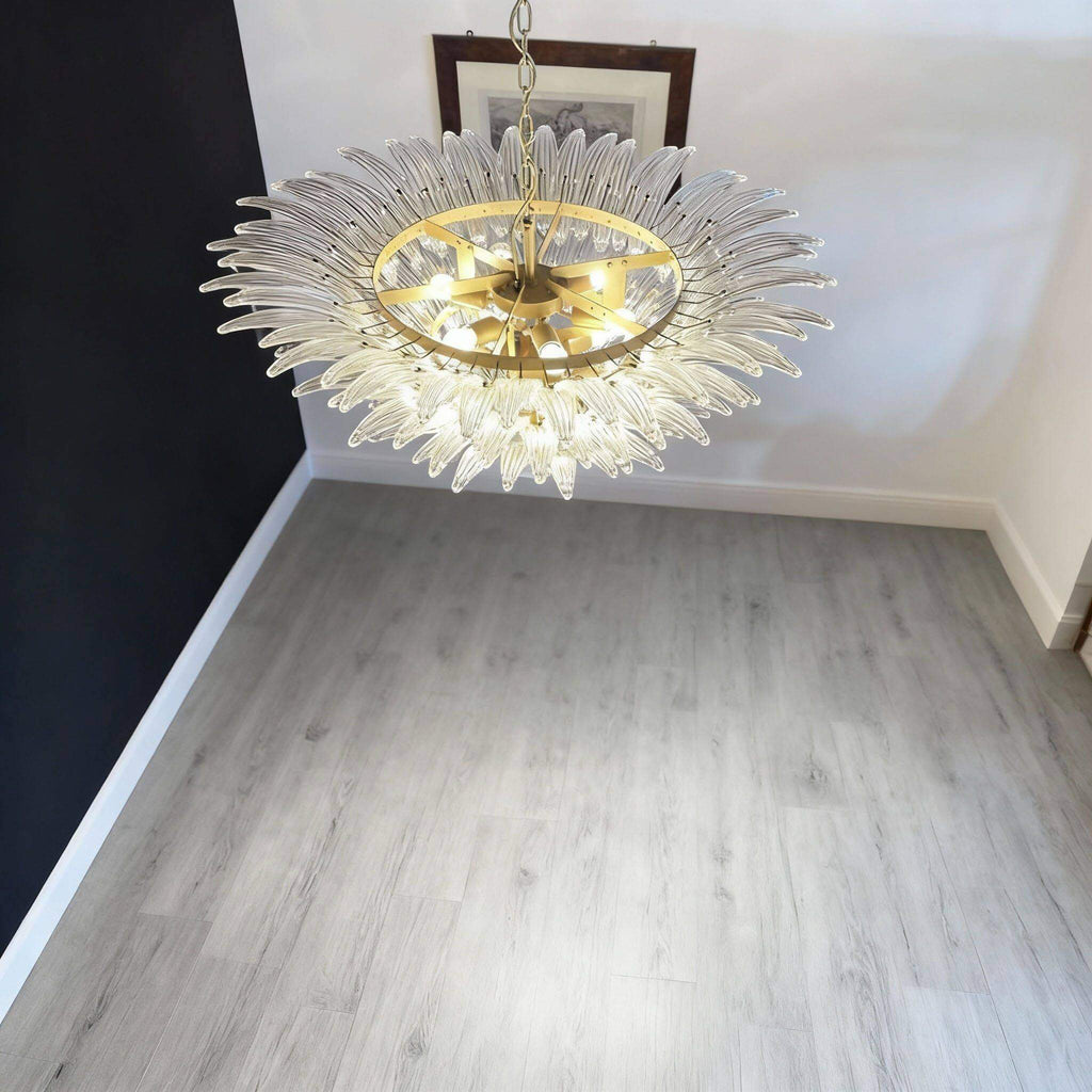 Clear glass Palmette chandelier glowing above a stairwell or landing.