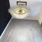 Clear glass Palmette chandelier glowing above a stairwell or landing.
