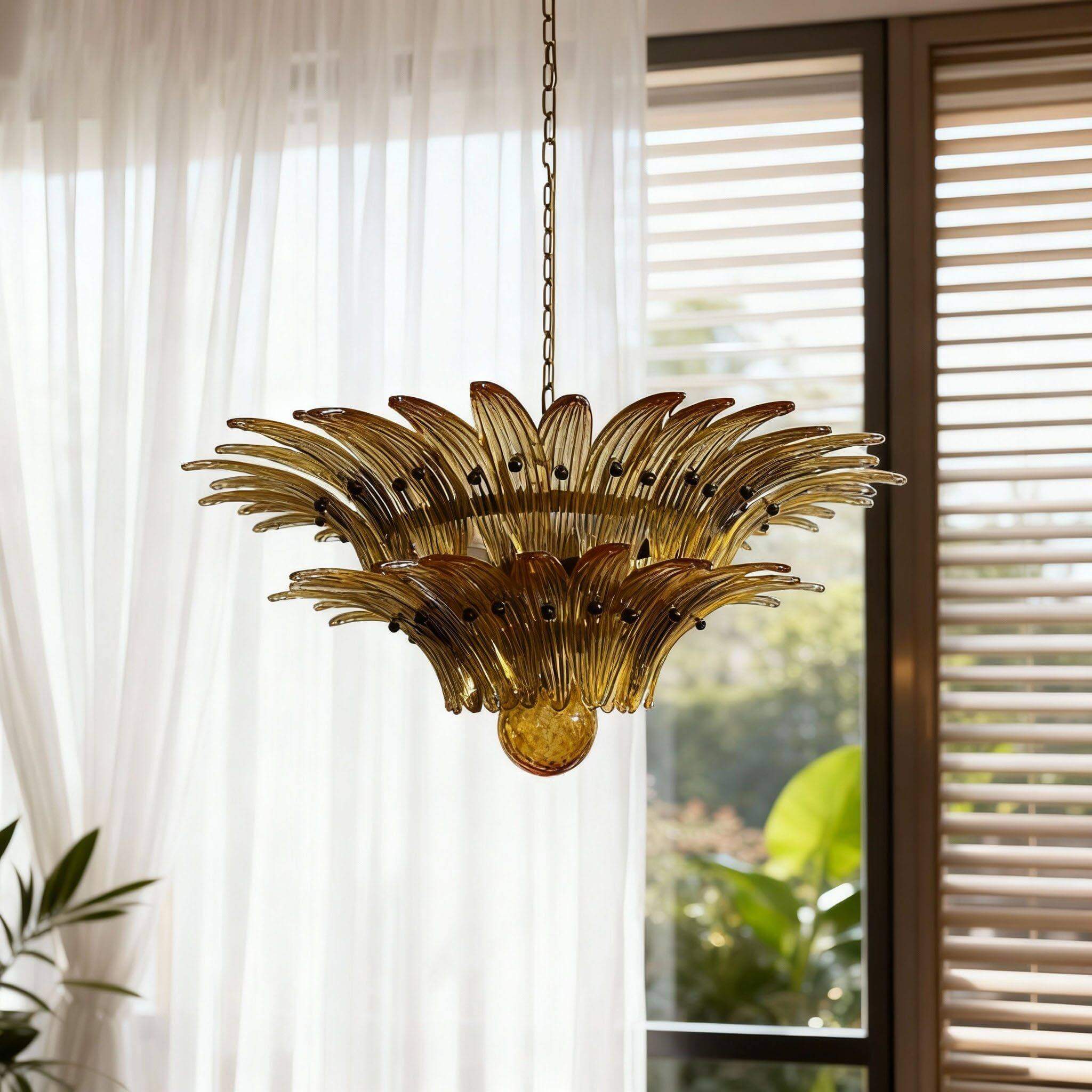 Amber glass chandelier shown close near sheer curtains and a window.